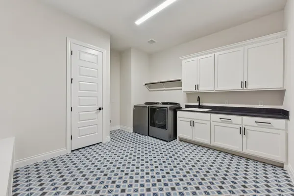 a kitchen with a refrigerator stove and white cabinets