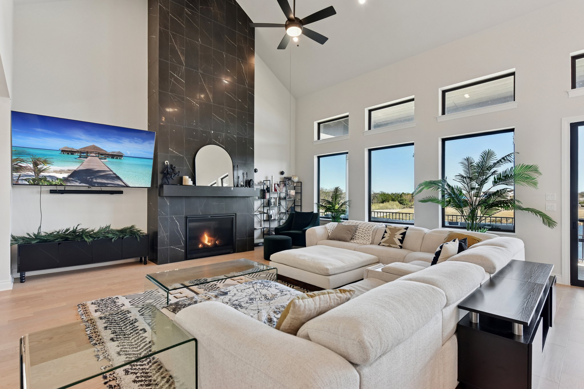 222 Rio Ranchero Road Georgetown, TX 78628 - Photo 6 of 40 a living room with furniture a fireplace and a floor to ceiling window