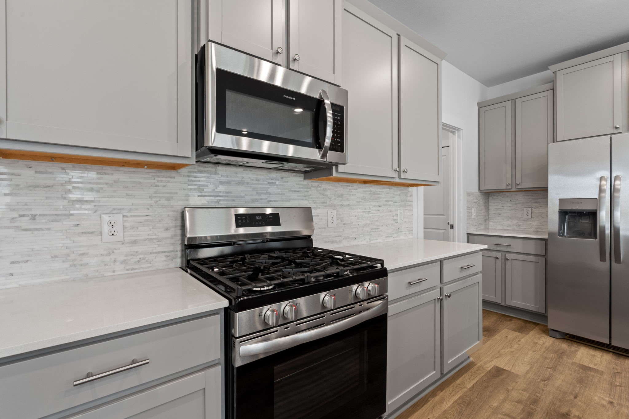 332 Gambels Quail Road Hempstead, TX 77445 - Photo 12 of 31 a kitchen with stainless steel appliances granite countertop a stove a sink and a microwave