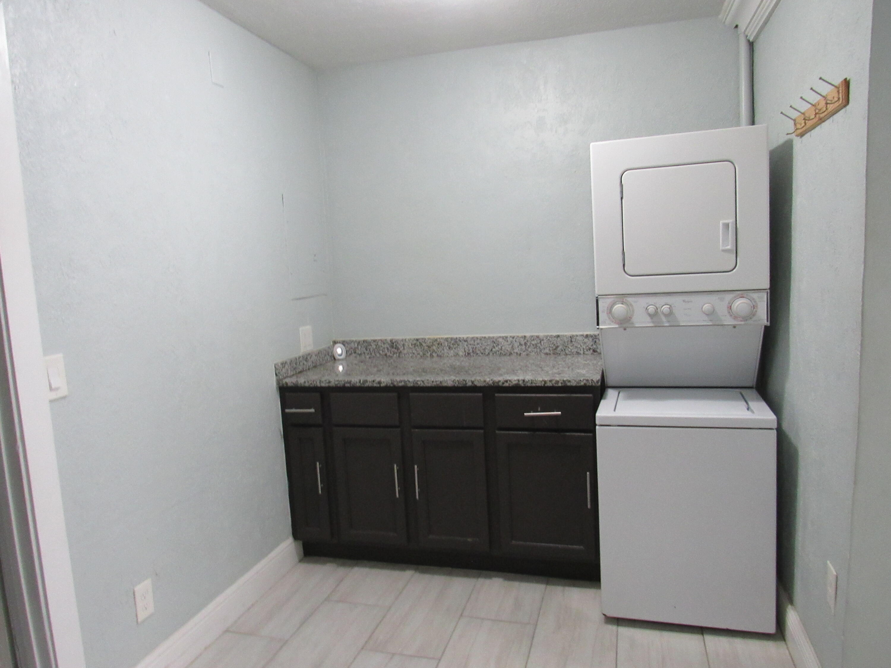 4283 Cocoanut Road, Unit 3 West Palm Beach, FL 33406 - Photo 7 of 13 Kitchen cabinet & Laundry