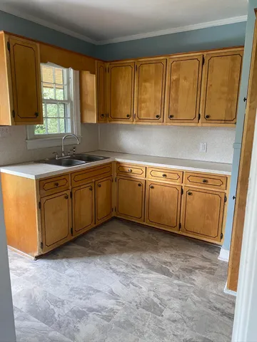 a kitchen with sink cabinets and window