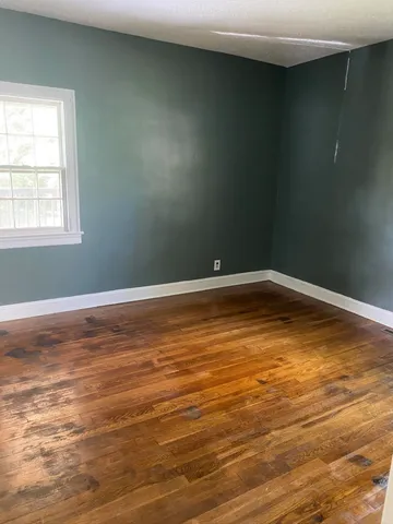 a view of a room with wooden floor