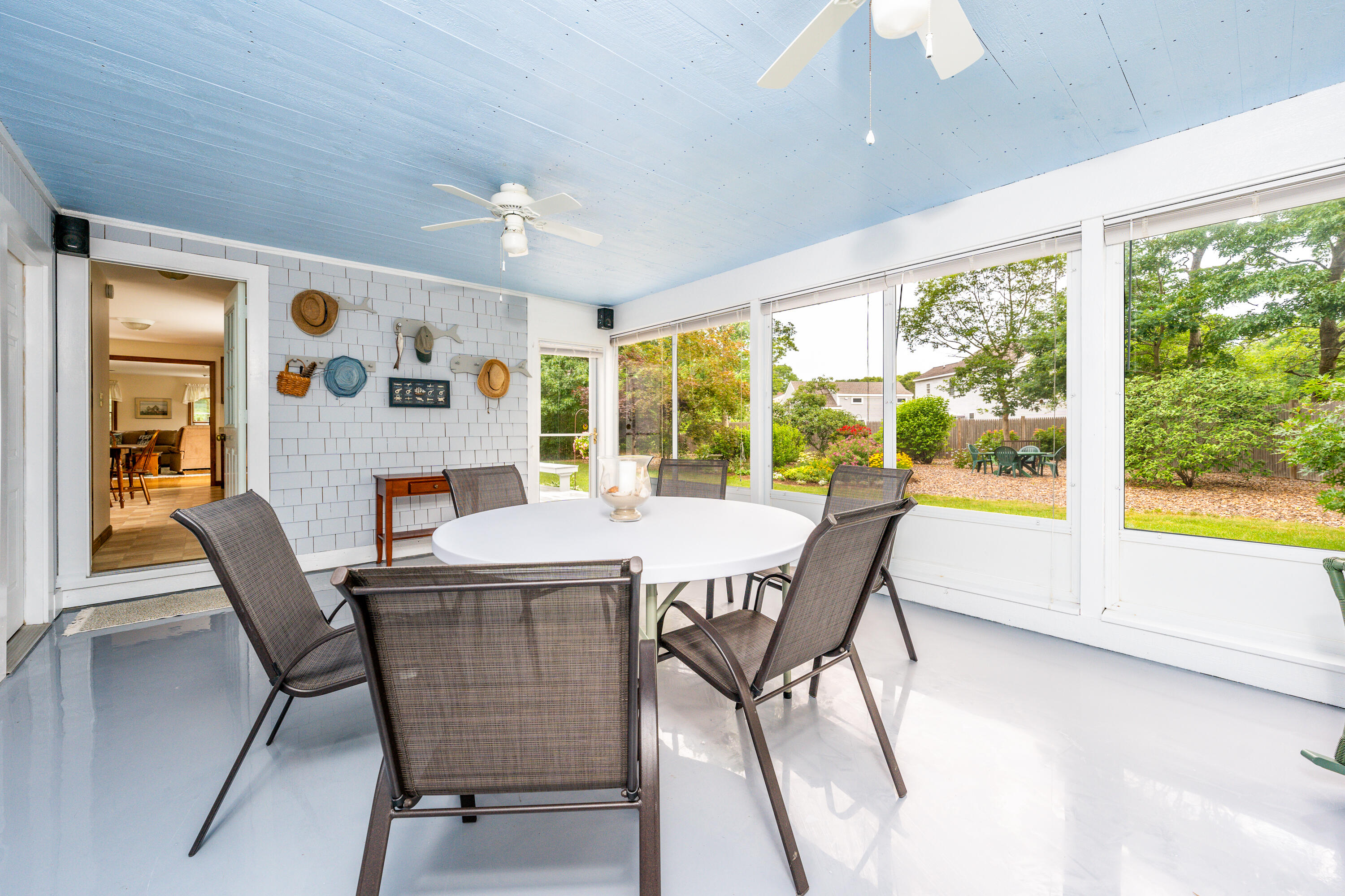 4 Leaf Lane Eastham, MA 02642 - Photo 21 of 39 a dining room with furniture large windows and wooden floor