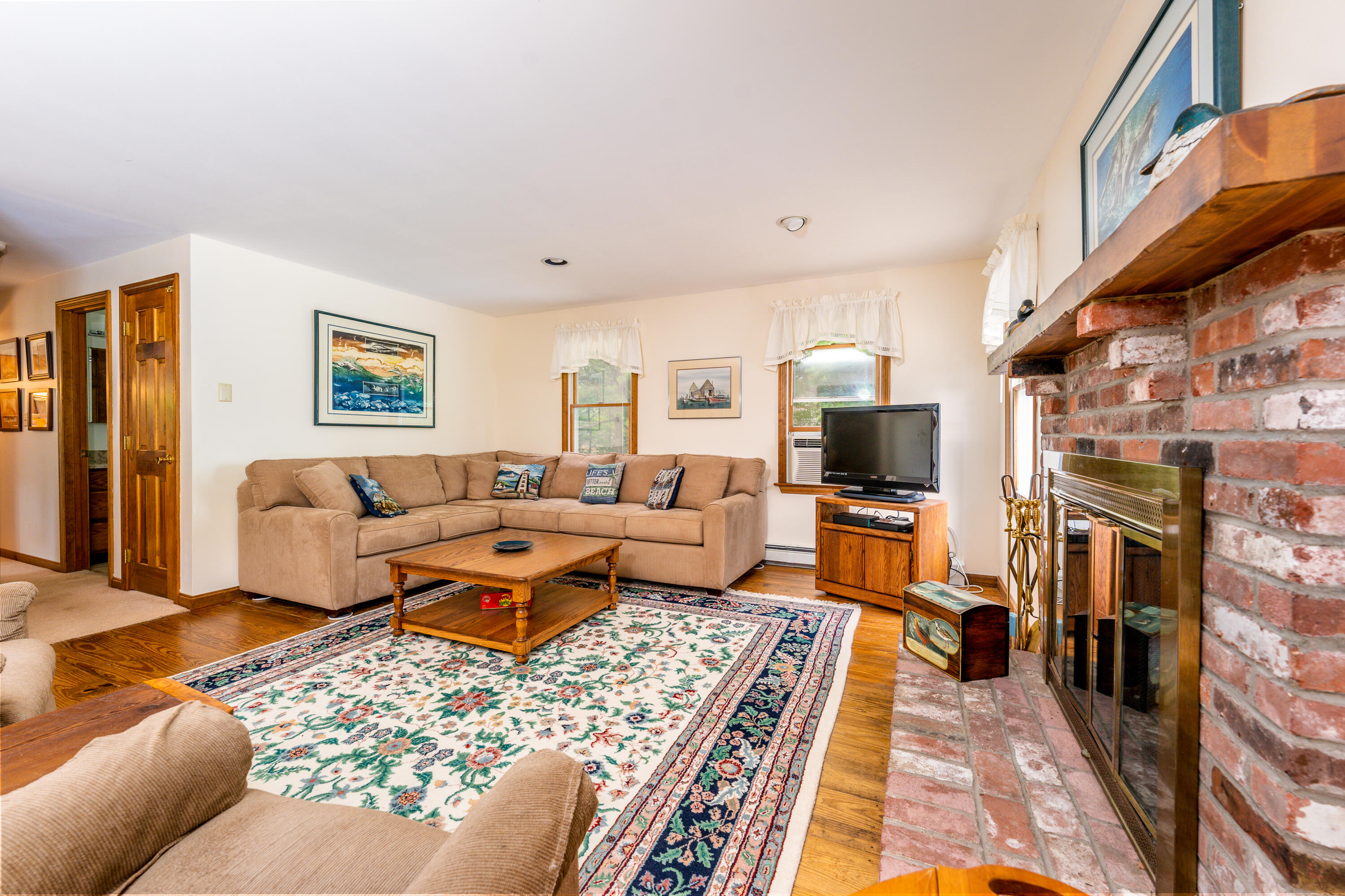 4 Leaf Lane Eastham, MA 02642 - Photo 25 of 39 a living room with furniture fireplace and a rug