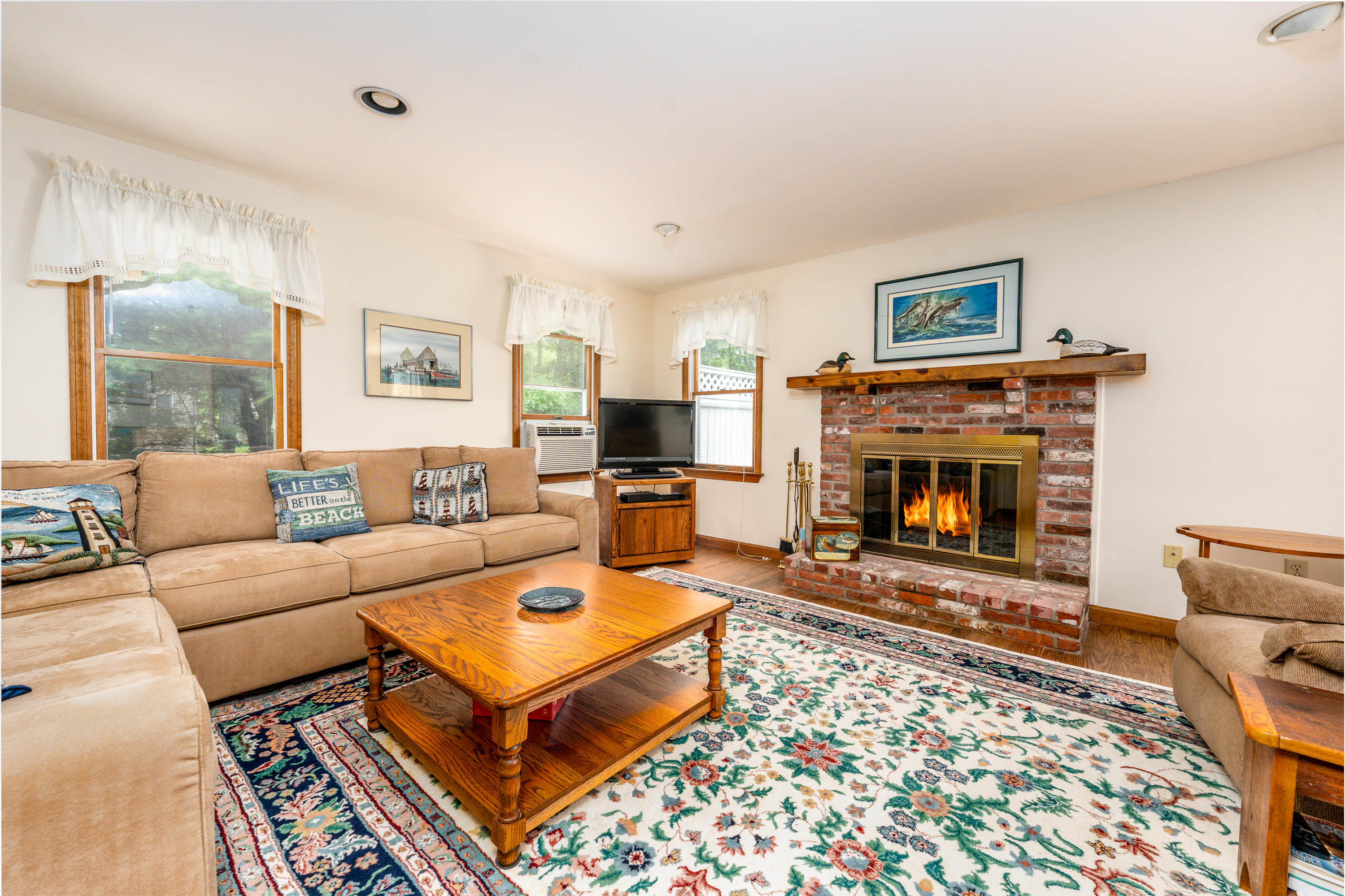 4 Leaf Lane Eastham, MA 02642 - Photo 26 of 39 a living room with furniture a flat screen tv and a fireplace