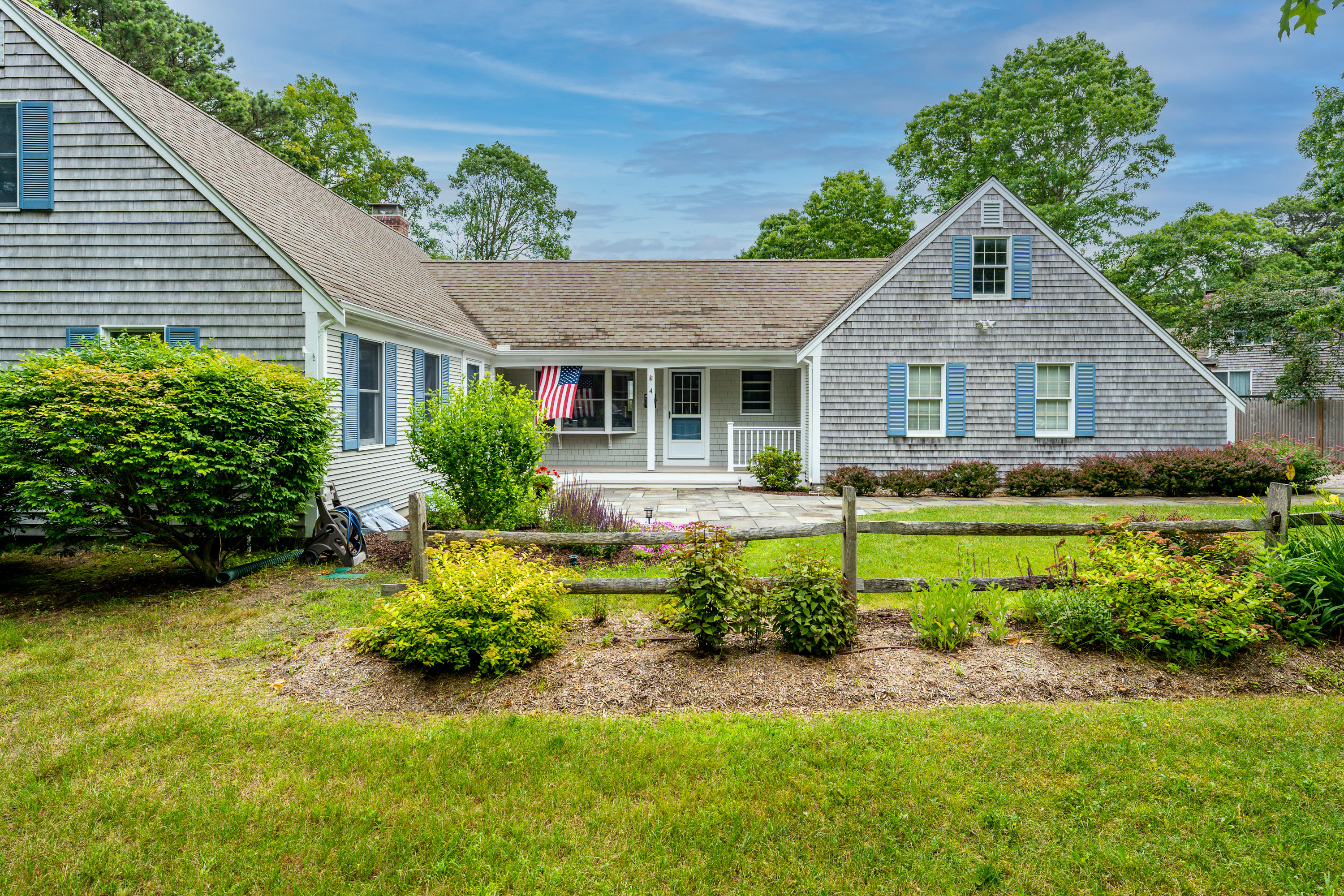 4 Leaf Lane Eastham, MA 02642 - Photo 3 of 39 a front view of a house with a yard and garage
