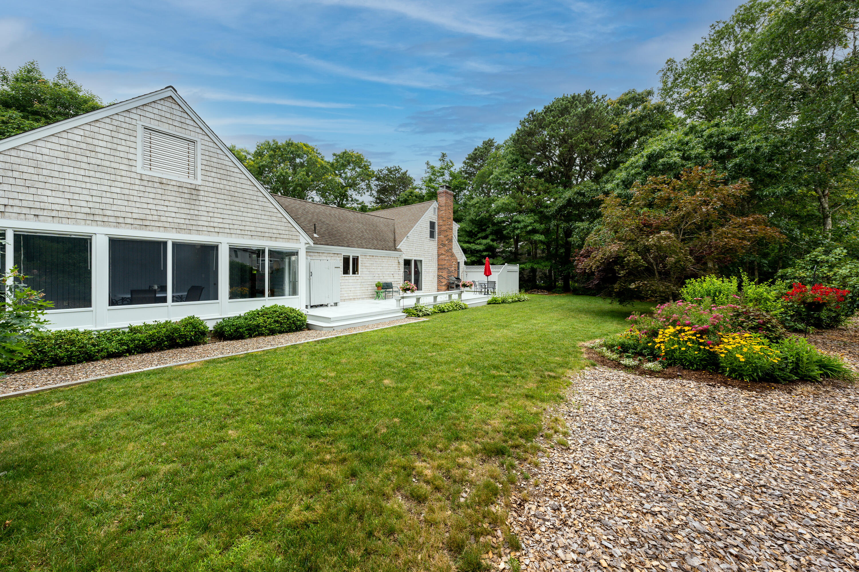 4 Leaf Lane Eastham, MA 02642 - Photo 6 of 39 a front view of a house with a yard
