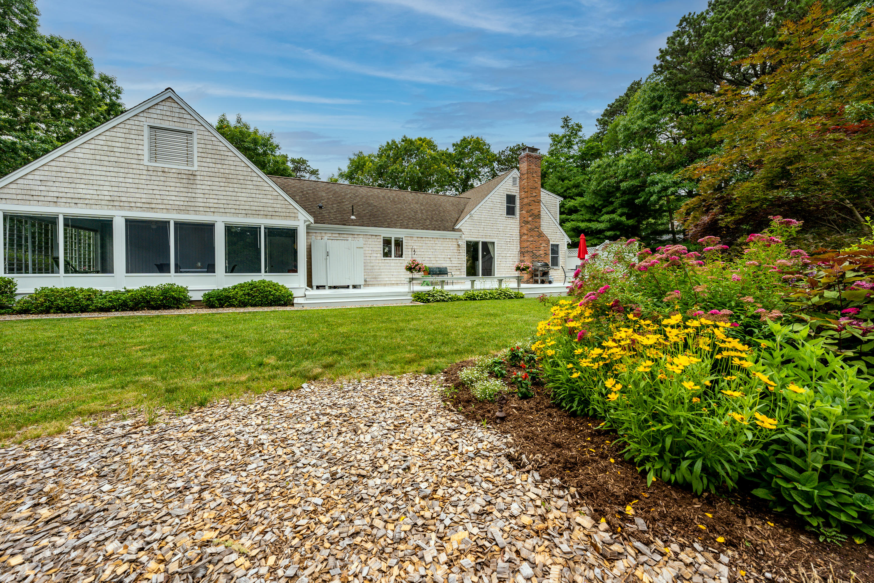 4 Leaf Lane Eastham, MA 02642 - Photo 7 of 39 a front view of a house with a garden