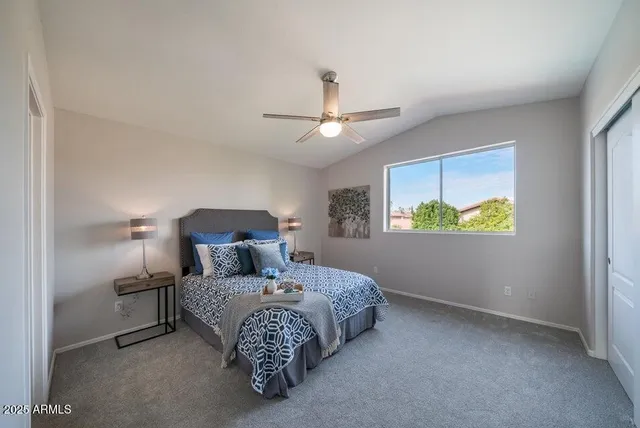 a bedroom with a bed and window