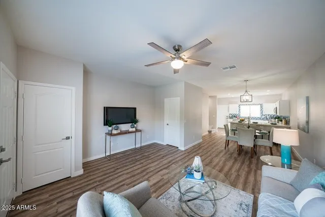 a living room with furniture and wooden floor