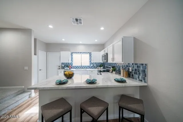 a kitchen with a table and chairs in it