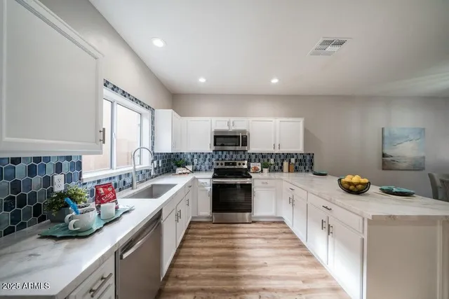a kitchen with a sink stove top oven and cabinets
