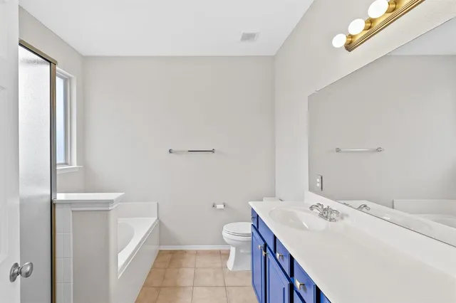 a bathroom with a sink a toilet and tub