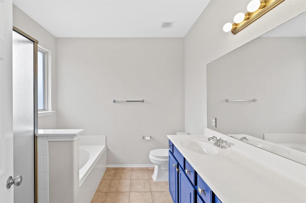 5812 Pebble Ridge Drive McKinney, TX 75070 - Photo 14 of 29 a bathroom with a sink a toilet and tub