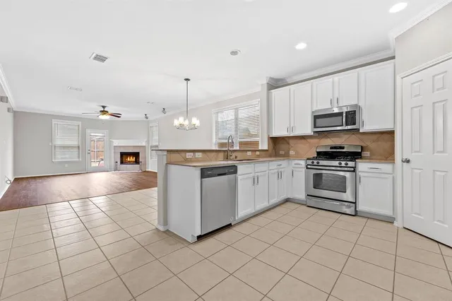 a kitchen with stainless steel appliances cabinets a sink and a stove