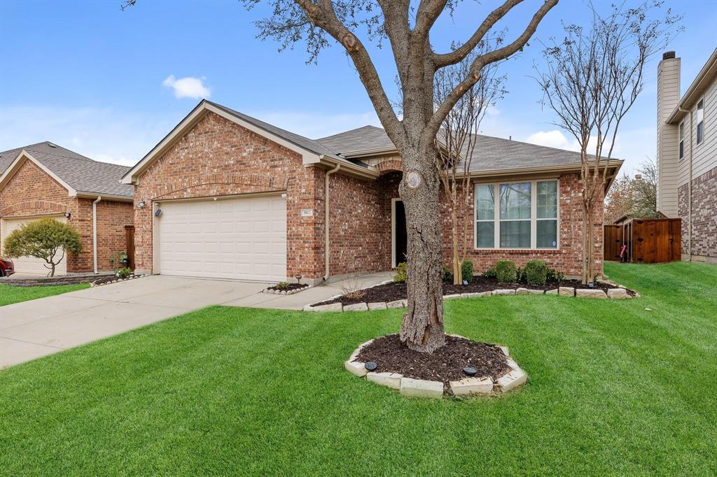 5812 Pebble Ridge Drive McKinney, TX 75070 - Photo 2 of 29 a front view of a house with a yard