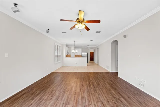 a view of a room with wooden floor ceiling fan