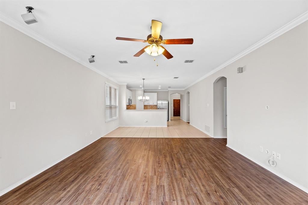 5812 Pebble Ridge Drive McKinney, TX 75070 - Photo 25 of 29 a view of a room with wooden floor ceiling fan