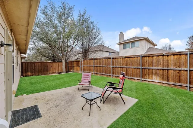 a view of a house with backyard sitting area and garden
