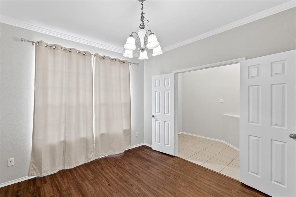 5812 Pebble Ridge Drive McKinney, TX 75070 - Photo 4 of 29 a view of an empty room with wooden floor and a window