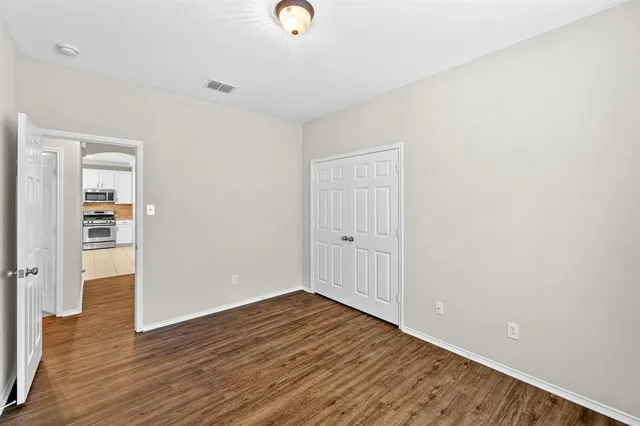 a view of an empty room and wooden floor