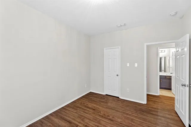 a view of a room with wooden floor and brick walls