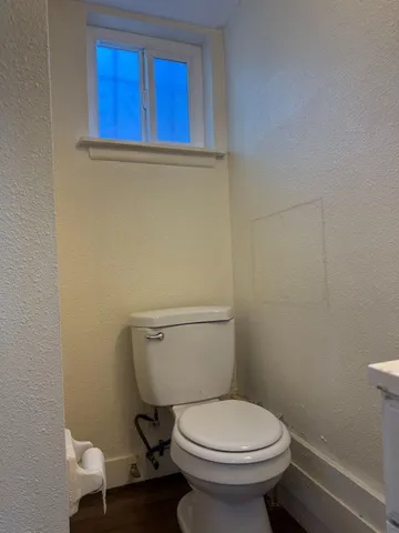 a kitchen with granite countertop white cabinets and a stove