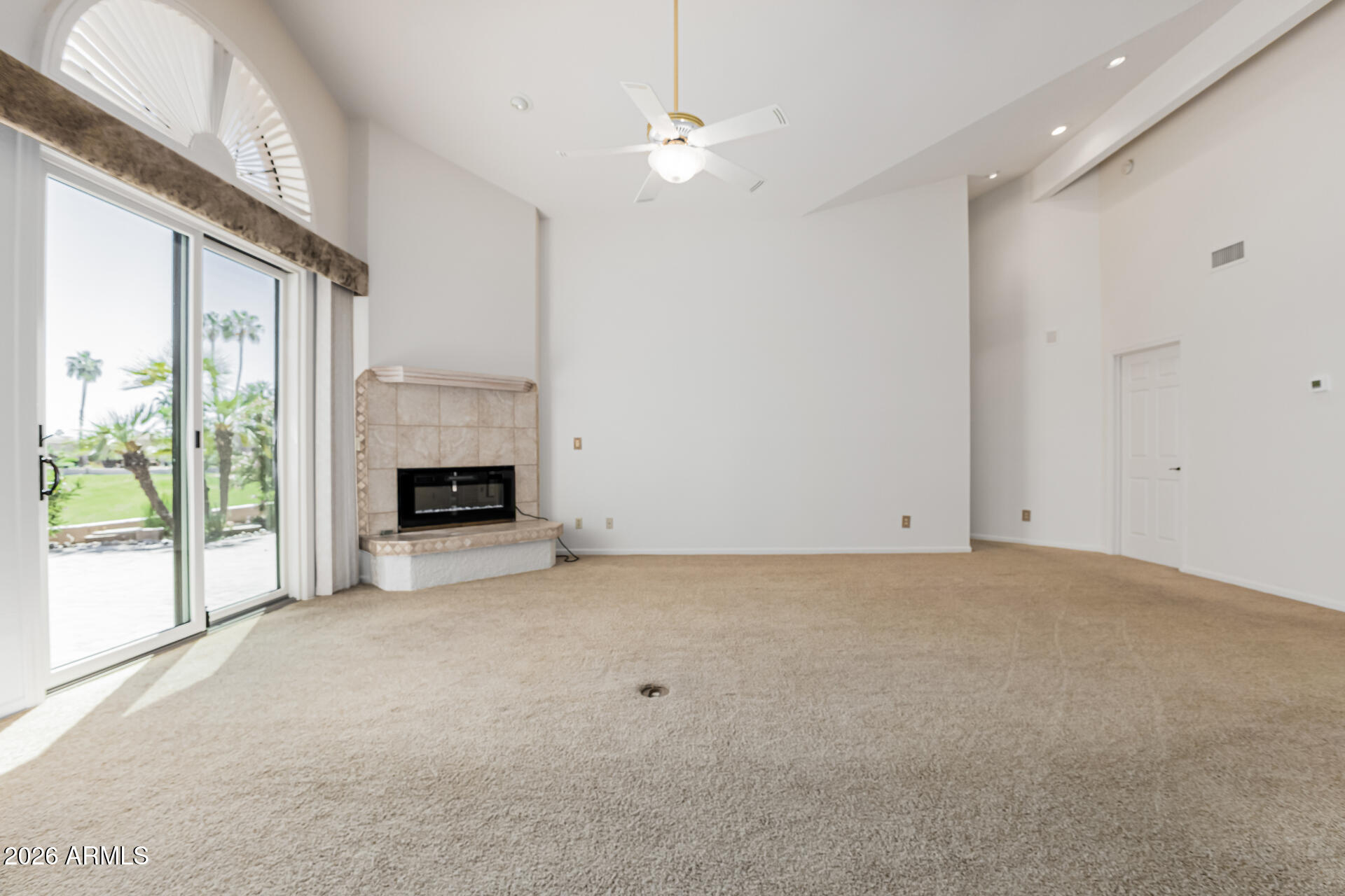 25615 North Bolero Bend, Unit 5 Rio Verde, AZ 85263 - Photo 12 of 57 a view of an empty room with windows and a fireplace