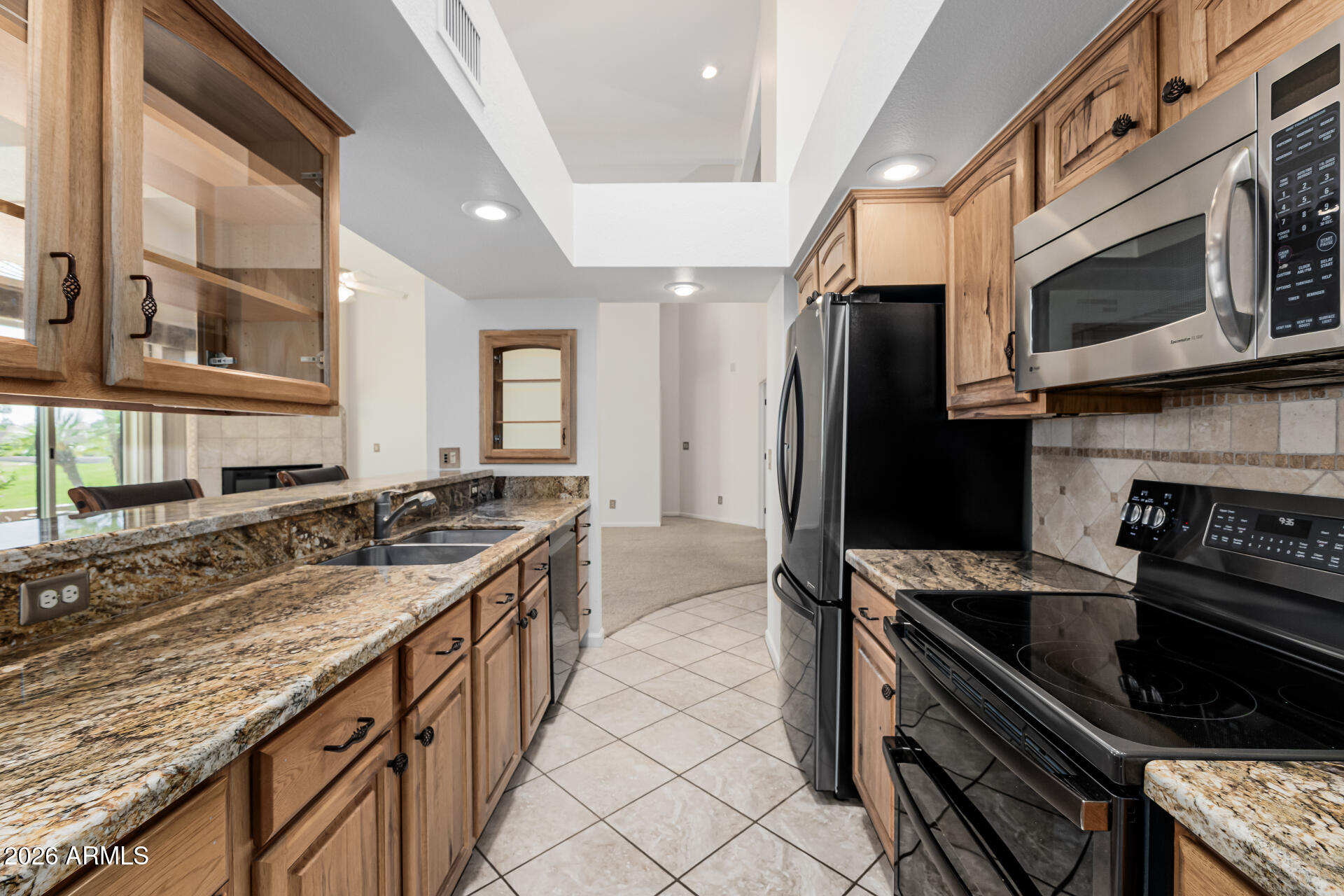 25615 North Bolero Bend, Unit 5 Rio Verde, AZ 85263 - Photo 17 of 57 a kitchen with stainless steel appliances granite countertop a stove and a sink
