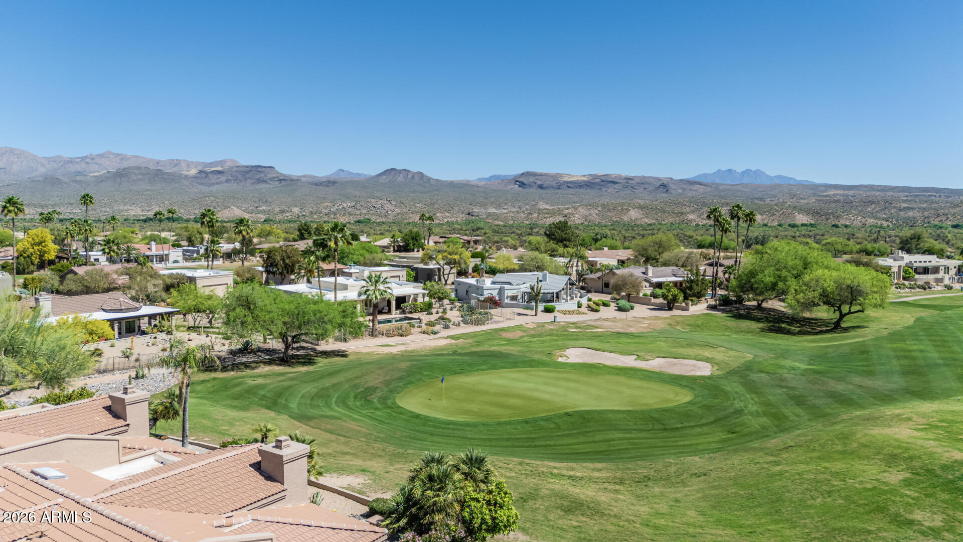 25615 North Bolero Bend, Unit 5 Rio Verde, AZ 85263 - Photo 45 of 57 a view of a lush green field with mountains in the background