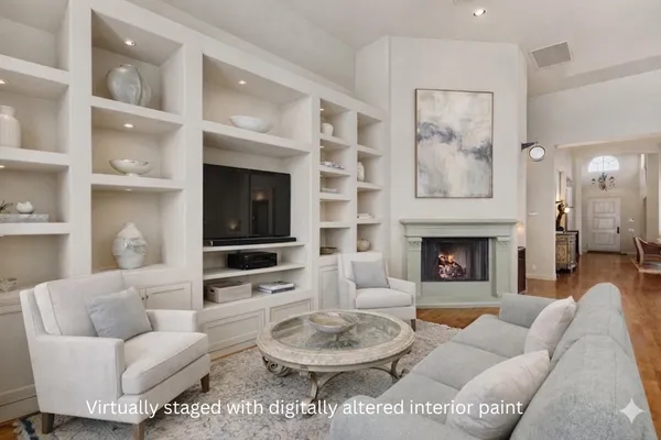 a kitchen with stainless steel appliances a dining table chairs and a refrigerator