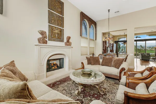 a living room with furniture a rug and a fireplace