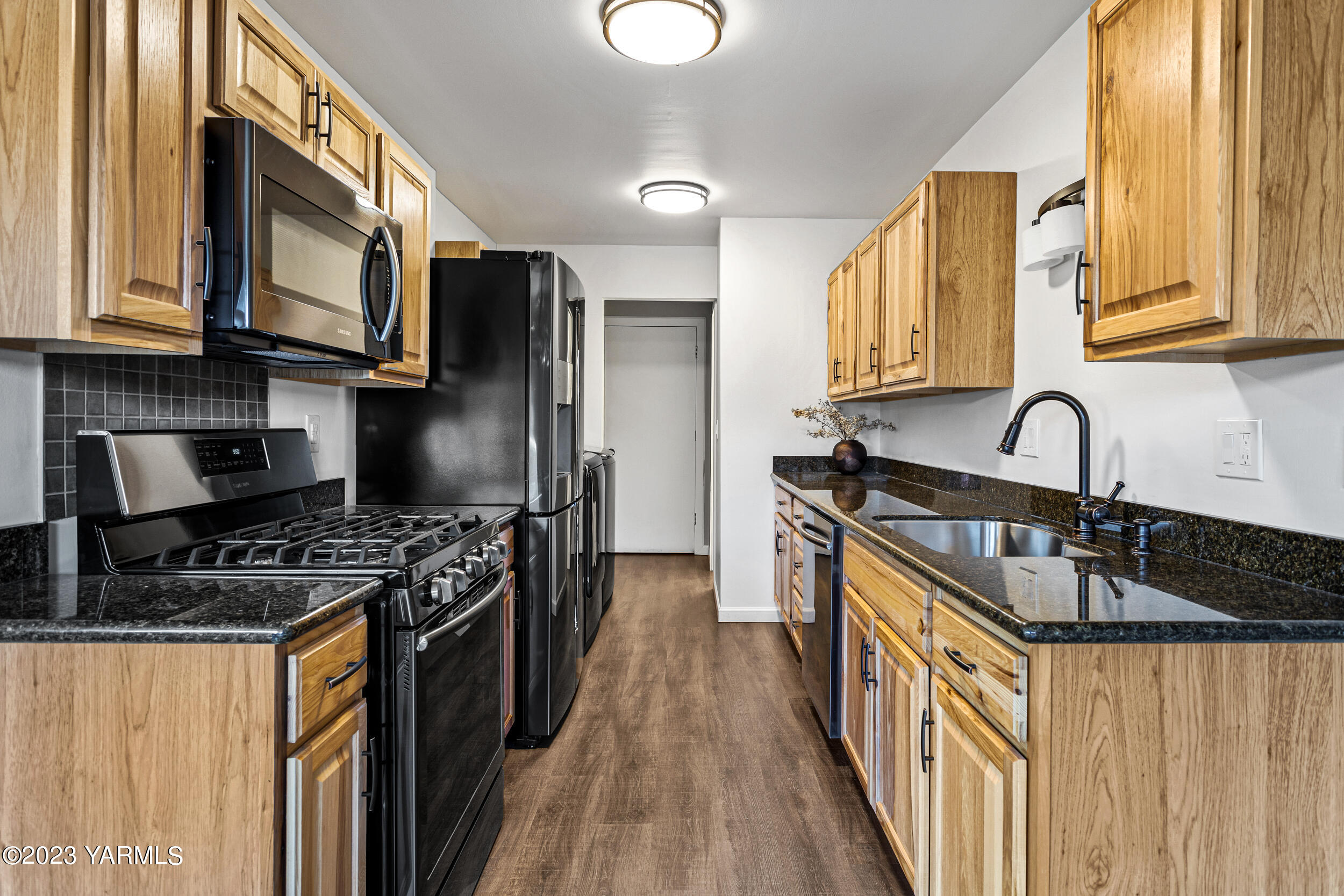1 Crest Circle Yakima, WA 98908 - Photo 14 of 30 a kitchen with granite countertop a stove a sink and a microwave