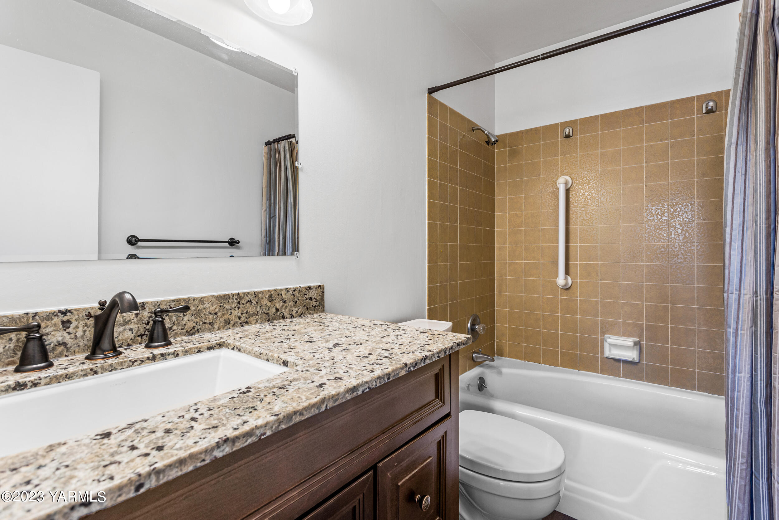 1 Crest Circle Yakima, WA 98908 - Photo 24 of 30 a bathroom with a granite countertop sink a toilet a mirror a vanity and bathtub