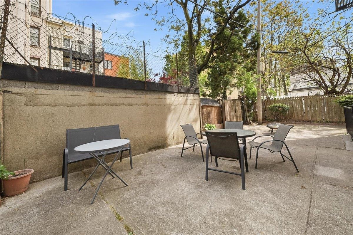 831 Clinton Street, Unit 11 Hoboken, NJ 07030 - Photo 16 of 21 a view of a patio with a table and chairs