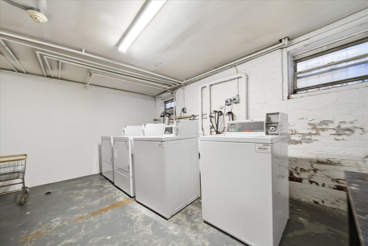 831 Clinton Street, Unit 11 Hoboken, NJ 07030 - Photo 17 of 21 a utility room with cabinets washer and dryer