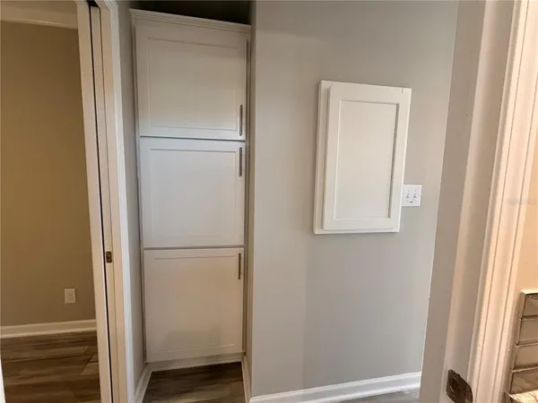a view of livingroom with entryway and wooden floor
