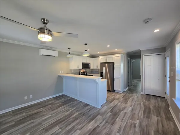 a kitchen with refrigerator and a microwave