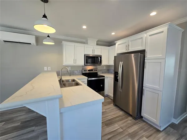 a kitchen with a stove sink and refrigerator