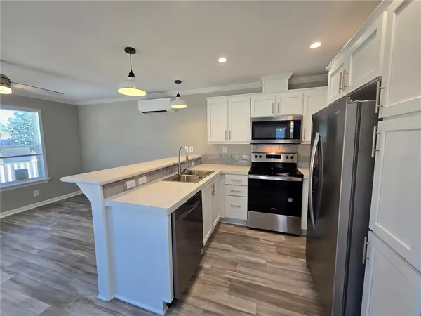 a kitchen that has a sink and a stove in it