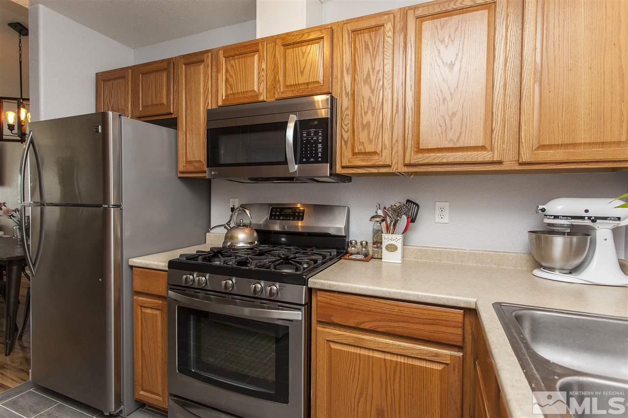 840 Roberts Street Reno, NV 89502 - Photo 11 of 25 a kitchen with stainless steel appliances granite countertop a refrigerator stove and sink