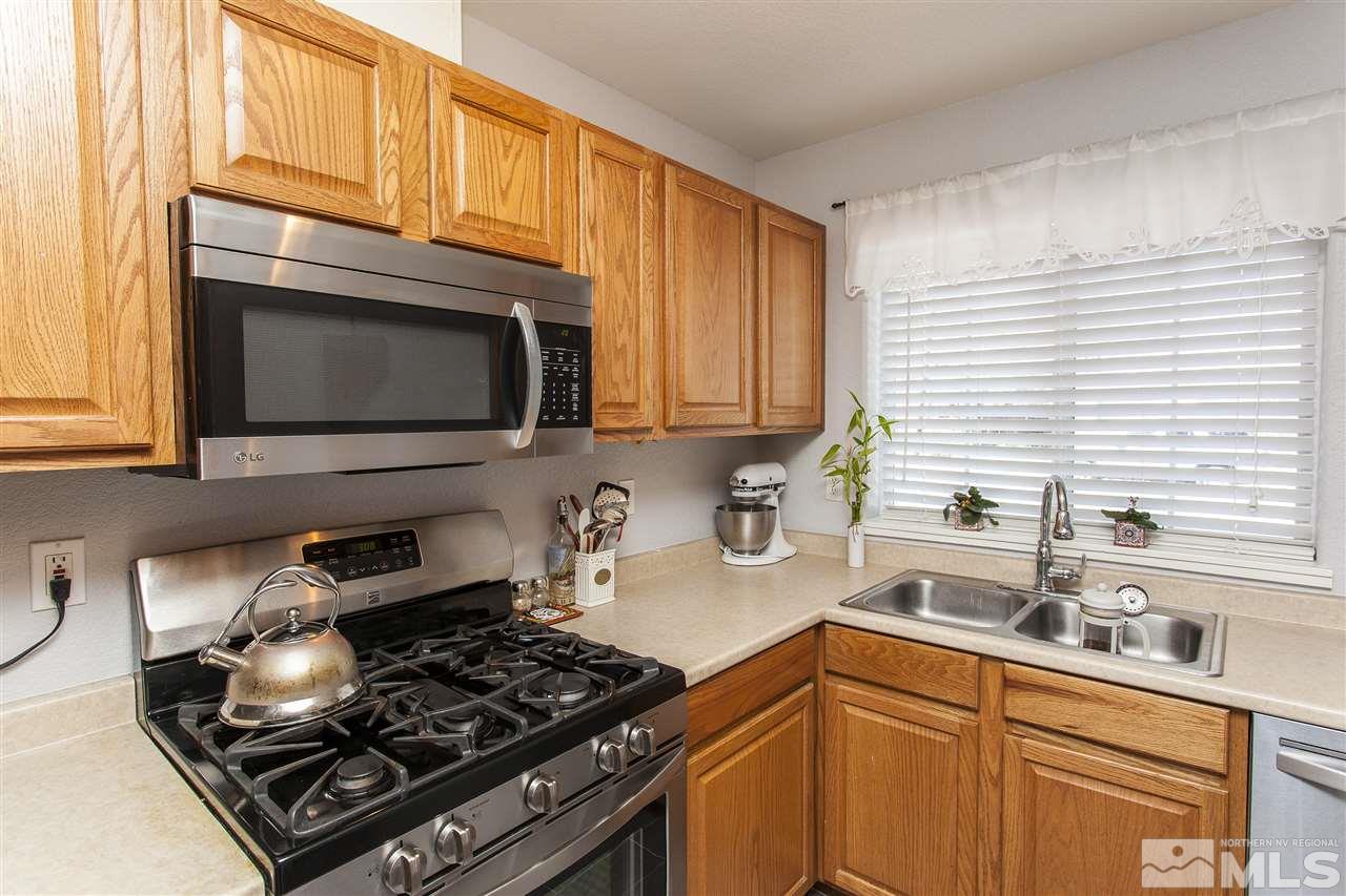 840 Roberts Street Reno, NV 89502 - Photo 12 of 25 a kitchen with stainless steel appliances granite countertop a sink stove and microwave