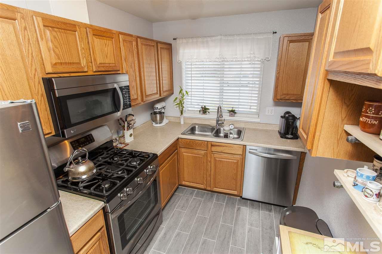 840 Roberts Street Reno, NV 89502 - Photo 13 of 25 a kitchen with wooden cabinets and a stove top oven