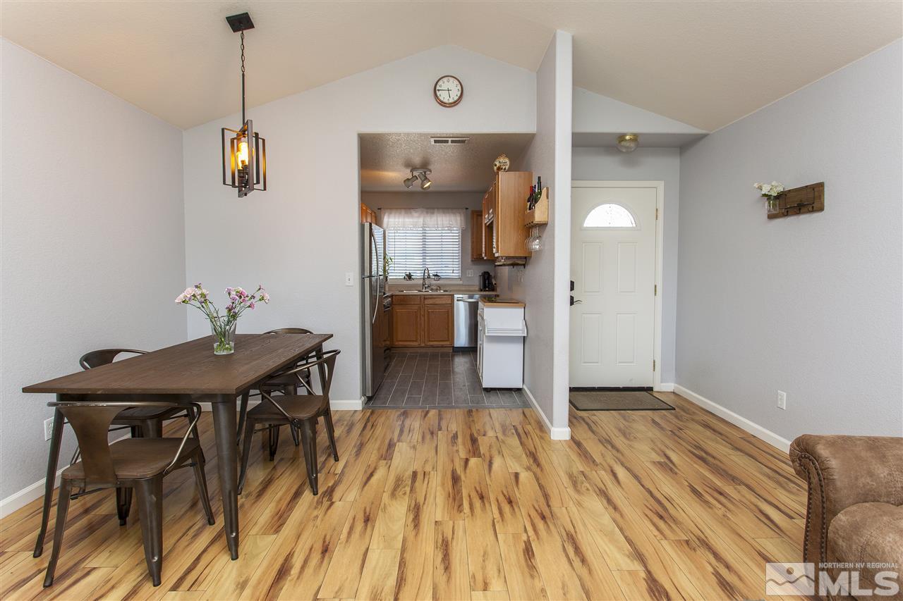 840 Roberts Street Reno, NV 89502 - Photo 3 of 25 a view of a dining room with furniture wooden floor and a chandelier