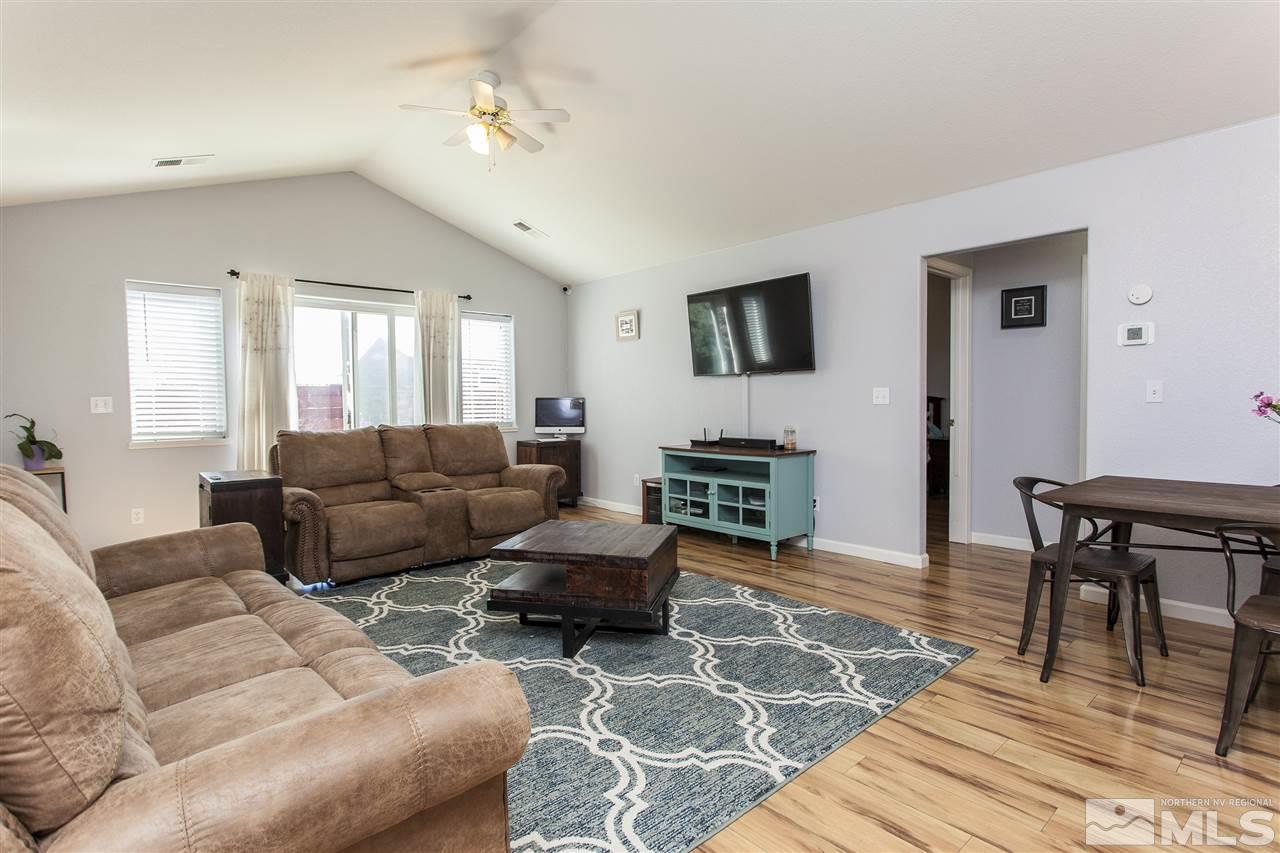 840 Roberts Street Reno, NV 89502 - Photo 5 of 25 a living room with furniture a dining table and a flat screen tv
