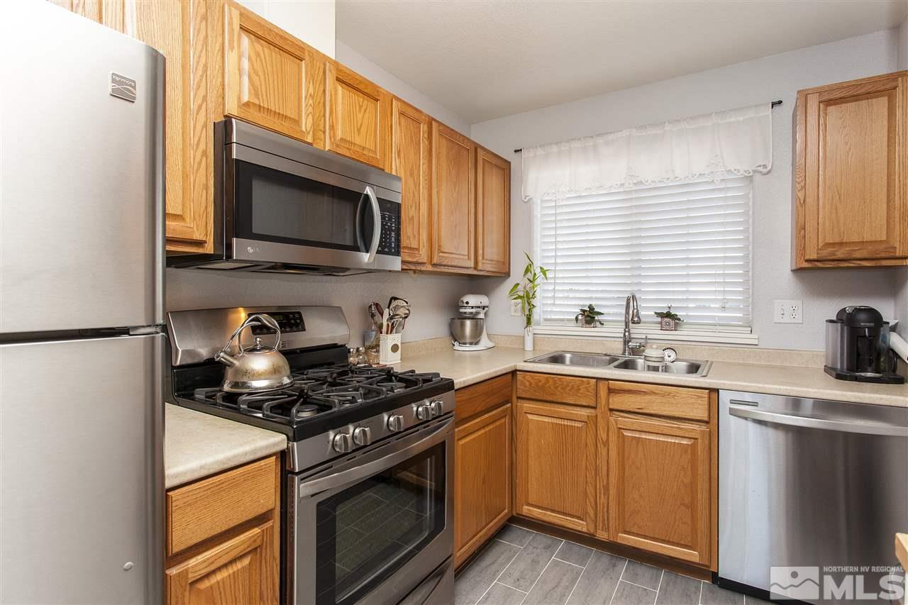 840 Roberts Street Reno, NV 89502 - Photo 10 of 25 a kitchen with stainless steel appliances granite countertop a sink stove microwave and refrigerator