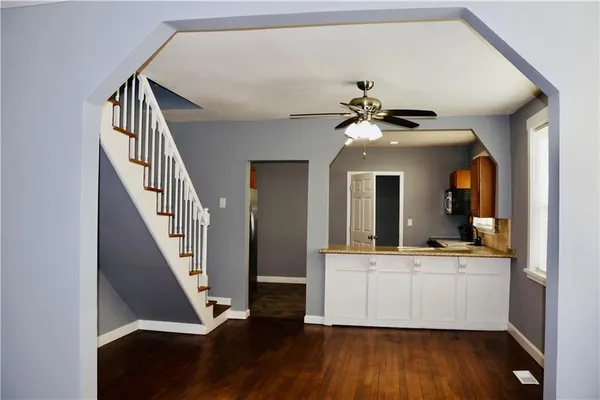 a view of living room with wooden floor and ceiling fan