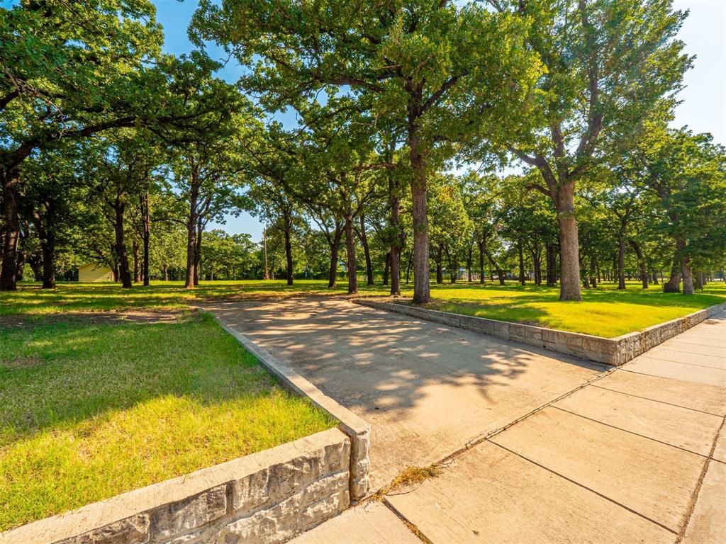 2801 Russell Road Arlington, TX 76001 - Photo 2 of 26 a view of swimming pool with trees in the background