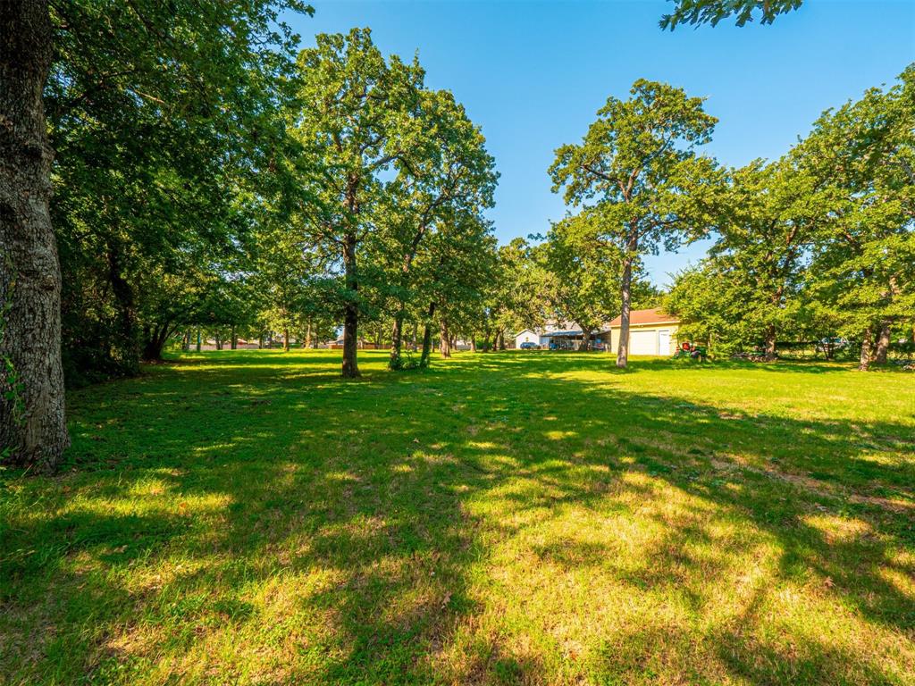 2801 Russell Road Arlington, TX 76001 - Photo 7 of 26 a view of grassy field with benches