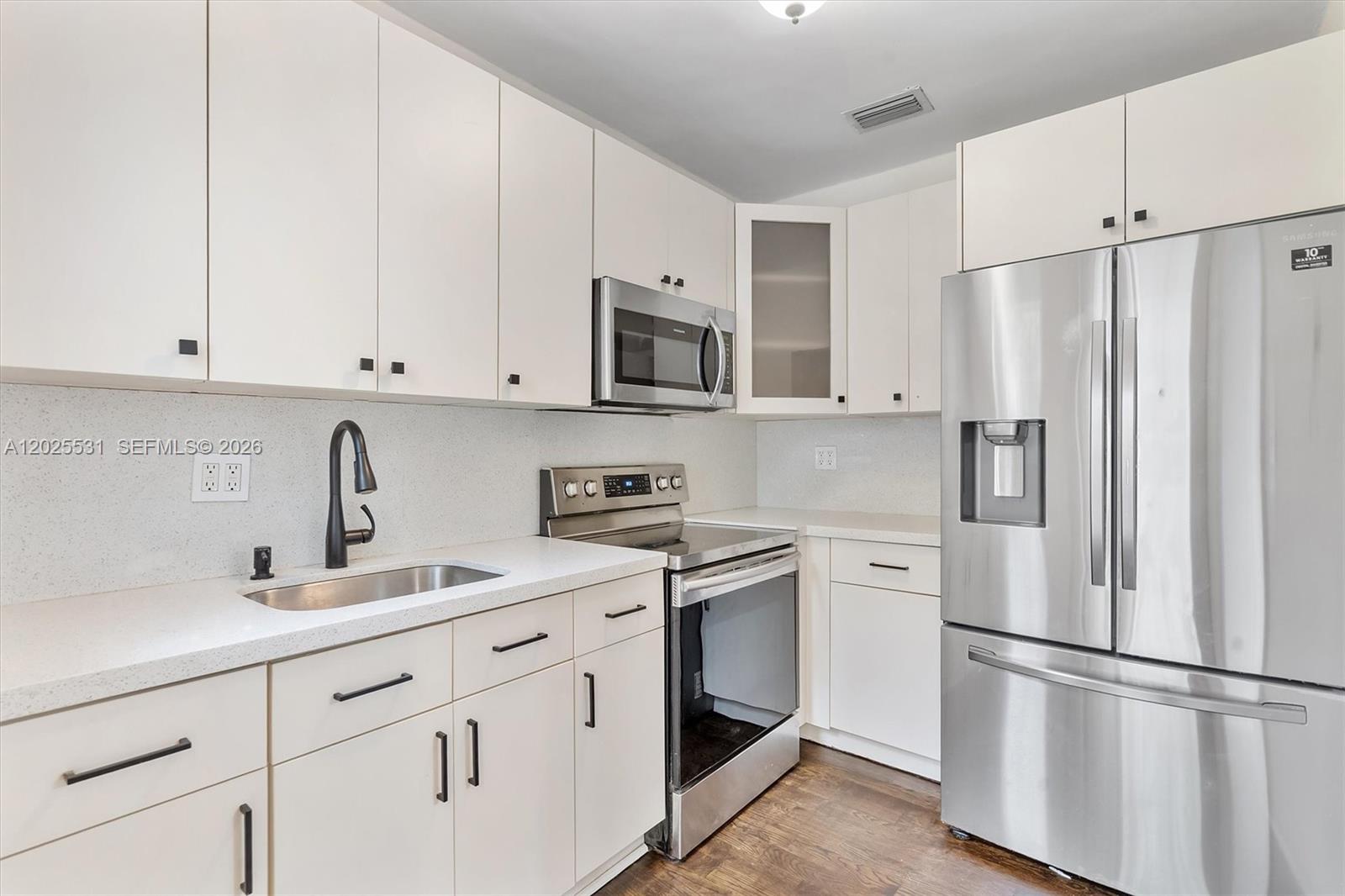 3951 Southwest 2nd Terrace, Unit 3951 Miami, FL 33134 - Photo 5 of 21 a kitchen with cabinets stainless steel appliances and a sink